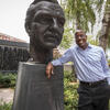 President Jason Wingard stands beside a bust of Temple University founder Russel Conwell.