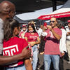 Image of Jason Wingard with a girl wearing a Temple cherry and white tee shirt.