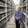 Image of Margery Sly in front of rows of gray boxes.