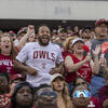 Image of a smiling college football fans wearing Temple-branded shirts.
