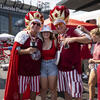 People wearing cherry and white shirts at a Temple University homecoming event.