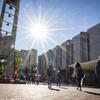Students walking toward the Bell Tower on a sunny day.