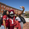 A photo of students taking a photo with Hooter.