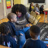 A Temple Jumpstart member reading to preschool children in a classroom at St. Malachy