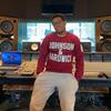Ben Thomas wearing a Johnson & Hardwick sweatshirt in a studio