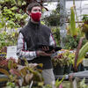 Ben Snyder among plants in the Temple Ambler Greenhouse.