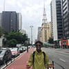 Xavier Burke standing at the center of a busy road in Sao Paulo, Brazil.