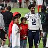 Shedeur Sanders pictured with two young men.