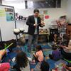 Steven Weiser, BYR 02, 04, teaches a percussion lesson to a group of students.