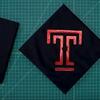 A graduation cap bedazzled with a Temple