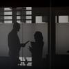 Two profiled silhouettes of two staff members talking with each other.
