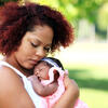 A mother holding a newborn baby girl.