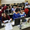 Temple students at computers helping residents file their taxes.