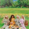 A photo of Barbie dolls having a picnic.