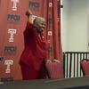Image of Temple University’s former fencing coach Nikki Franke, wearing a cherry suit and pumping her fist. 