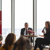 President John Fry and Professor Liz Moore speaking at a table in Morgan Hall in front of an audience