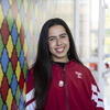 Raphaela leans against a colorful wall in the Art of Bread inside Tyler School of Art