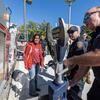 A firefighter shows a jaws of life to a student. 