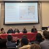 image of conference attendees and the panel