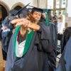 Image of smiling students hugging at PA graduation in Mitten Hall.