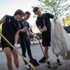 Image of men's soccer players cleaning up the area near Temple Sports Complex.