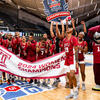 Image of Temple women s basketball in the cherry and white celebrating on the court.
