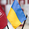 Image of the Ukrainian flag and two Temple flags.
