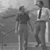 Image of two people walking down the steps of Tomlinson Theater.