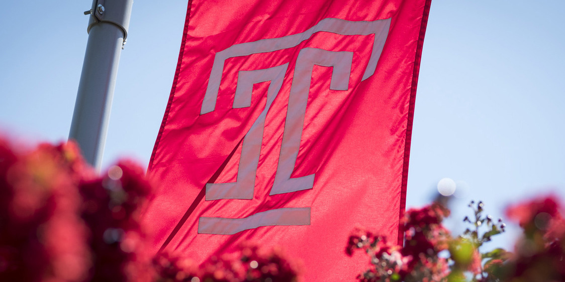 Temple flag flying above flowers