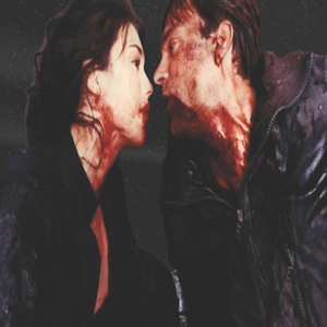 image of a man and woman in all black looking at each other