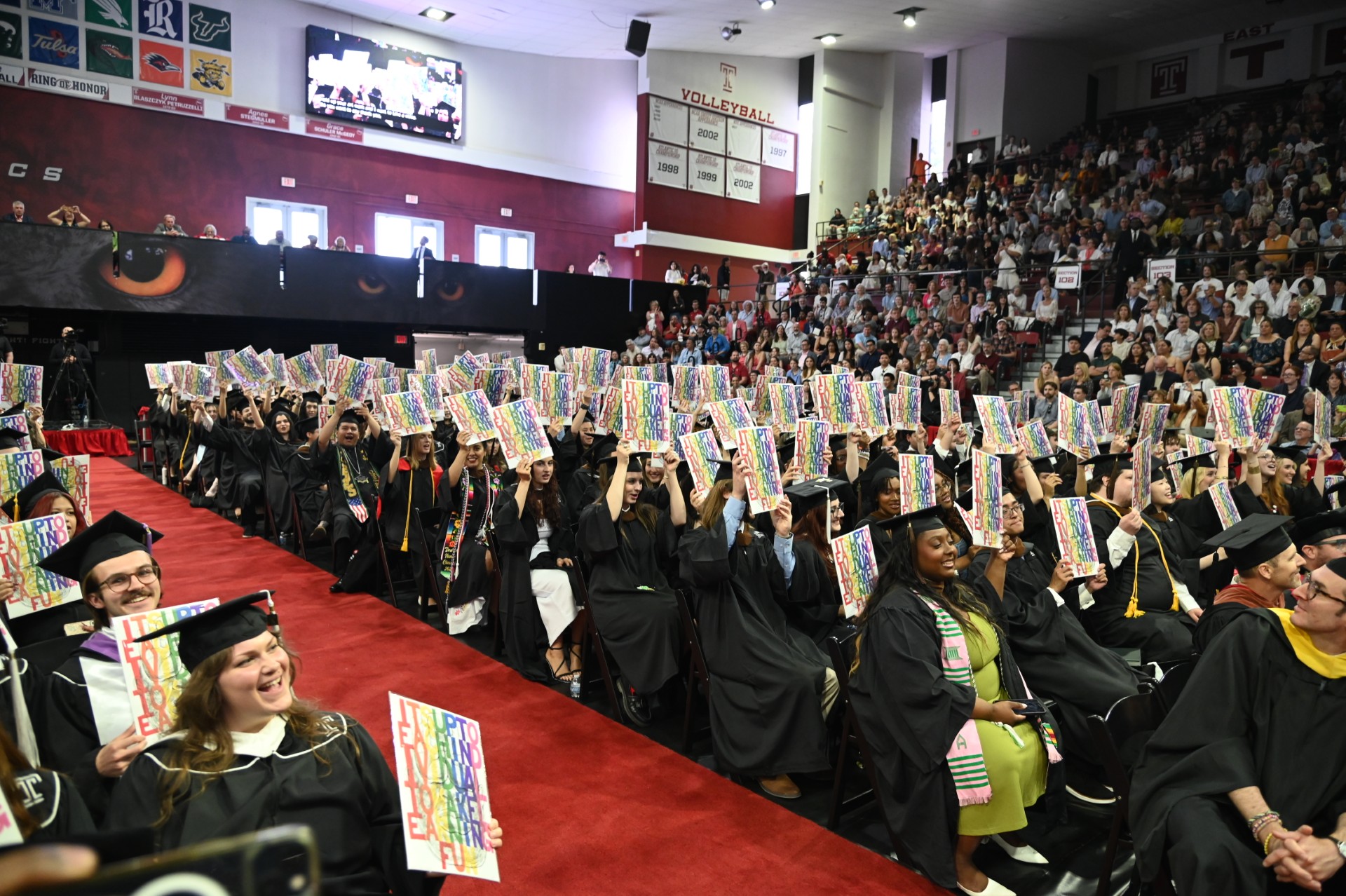 Tyler graduates holding up their Diploma Project print
