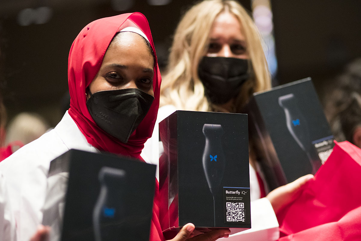 two medical students holding up their gift